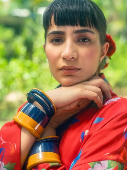 A close-up from my red kimono look, focusing on the bold, colorful bangles and soft makeup.