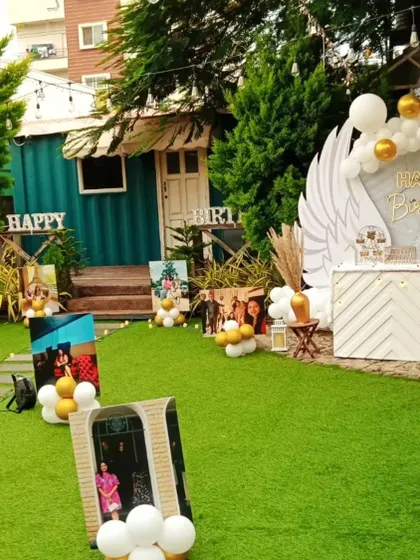 This garden party setup includes a personalized photo gallery, allowing guests to walk through and reminisce over special memories.