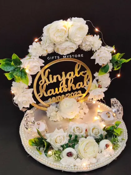 A touch of class for your engagement bliss. This exquisite all-white ring platter for Kinjal and Kaushal is lit with fairy lights.
