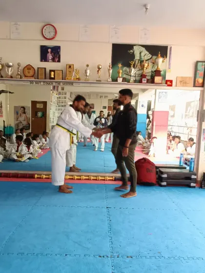 A handshake of congratulations for a student's promotion.