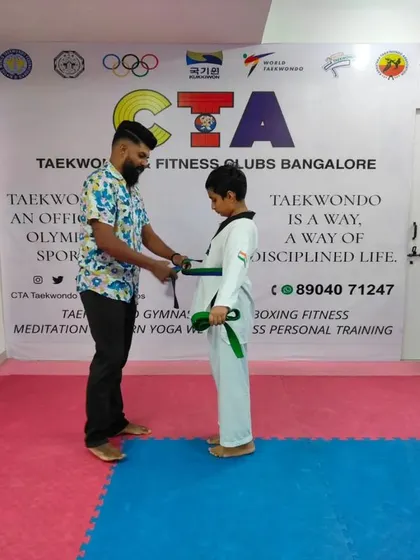 Tying a green belt.