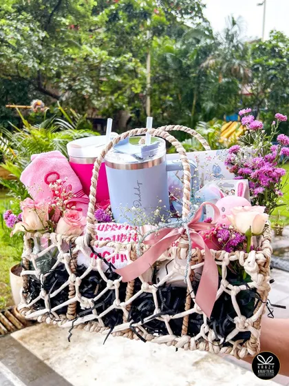 Another view of the stunning macrame baby shower basket, held outdoors to show its beautiful craftsmanship and generous size.