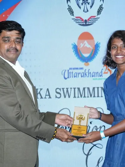 Our water polo athlete proudly receiving her award, a testament to her hard work and the success of our program.