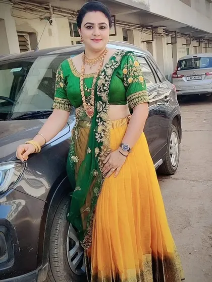 This yellow and green half saree is a vibrant and traditional outfit, perfect for festive occasions or photoshoots.