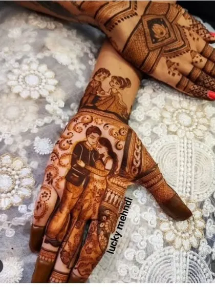 This engagement mehndi features two couple portraits. The main one on the palm is a romantic close-up, while a smaller, cuter caricature is on the forearm.