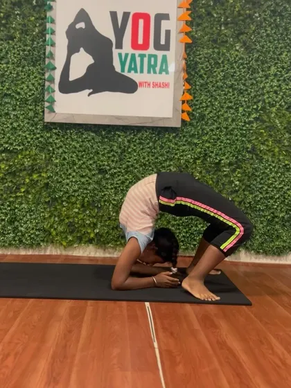 This student holds Dwi Pada Viparita Dandasana (Forearm Wheel Pose), an advanced backbend that requires significant strength and openness.