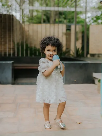 A sweet little girl enjoying a summer day outdoors. This candid shot captures her in a natural, relaxed moment, just being a kid.