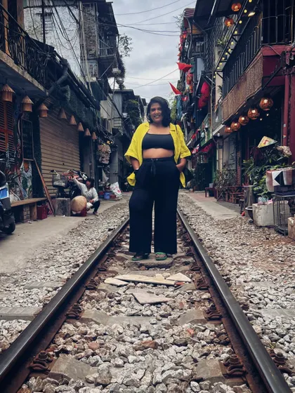 Another perspective of the train street. My wide-leg pants and crop top combination is a travel staple for me because it's so comfortable and versatile.