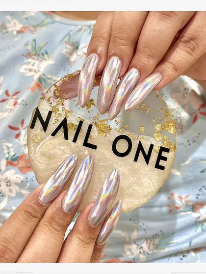 This is where nail art becomes a statement. We sculpted these long, almond-shaped acrylic extensions and finished them with a mesmerizing holographic chrome powder that catches the light from every angle. This look is for those who want their nails to be the center of attention.