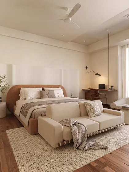 This bedroom is a study in soft minimalism and functionality. The curved, upholstered bed frame adds a gentle softness, while the integrated sofa at the foot of the bed and a dedicated work desk make it a versatile, multi-purpose sanctuary.