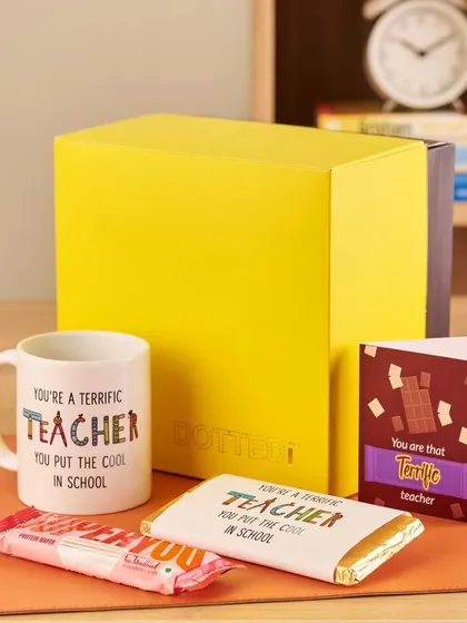A thoughtful Teacher's Day gift, this set includes a "Terrific Teacher" mug, matching chocolate bars, and a greeting card, all in a bright yellow gift box.