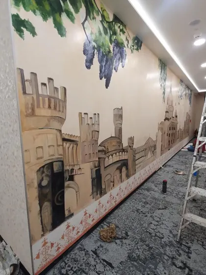 The mural is starting to take shape. You can see the ladder we use to reach the higher sections of these long corridor walls.