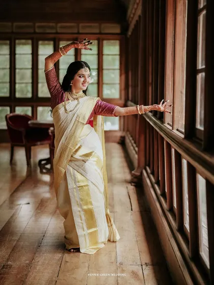 A portrait of the bride, Anjana, in a classic dance pose, showcasing the elegance of her Kerala kasavu saree. I love to incorporate elements of a bride's personality and talents into her wedding film.