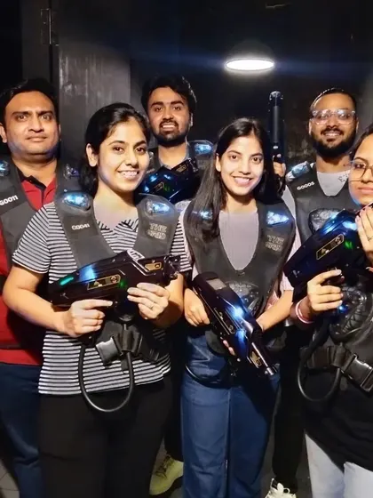 A team poses with their laser guns, ready for some friendly competition.
