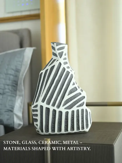 Here, the same geometric vase is styled on a bedside table. It demonstrates how a single, powerful art object can elevate an everyday space, turning a simple corner into a curated vignette.