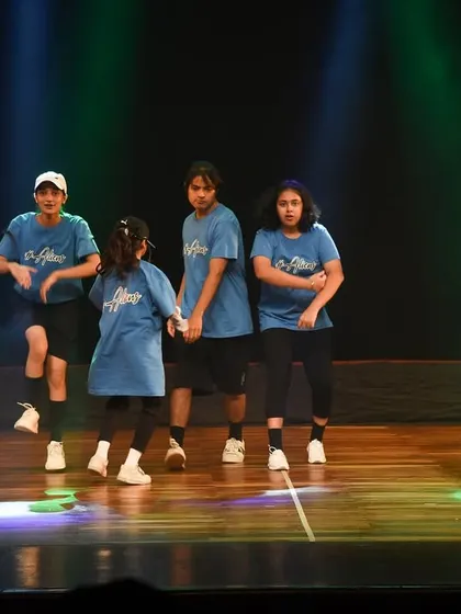 A candid moment of high energy and fun during the kids' hip hop performance.