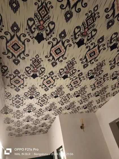 A wider view of the ceiling, showing how the wallpaper becomes a "fifth wall" of decor.