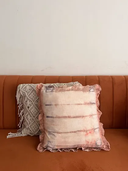 A wider view of the pillow cover, showing how it can be styled on a modern sofa. The colors are soft and come from natural sources, making it a healthy and sustainable choice for your home decor.