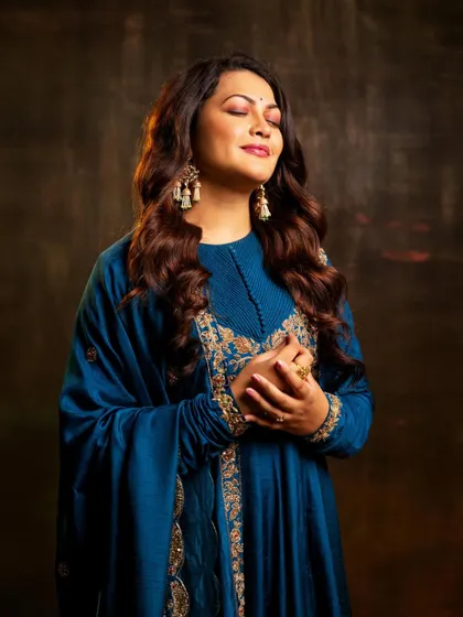 A serene, eyes-closed shot that captures a moment of musical bliss.
