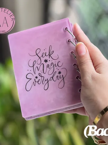 A personalized resin diary with the quote "Seek Magic Everyday", included as part of a custom Rakshabandhan hamper for a sister.