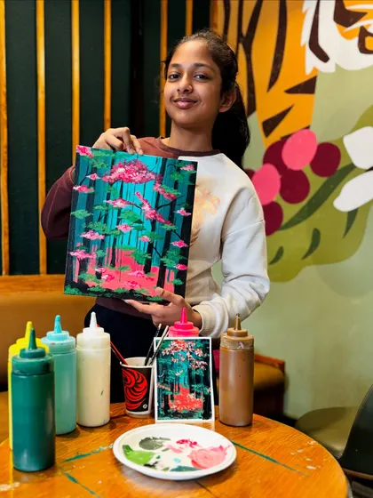 A proud young artist with her mystical forest painting. It's wonderful to see participants add their own creative touches to the theme of the day.