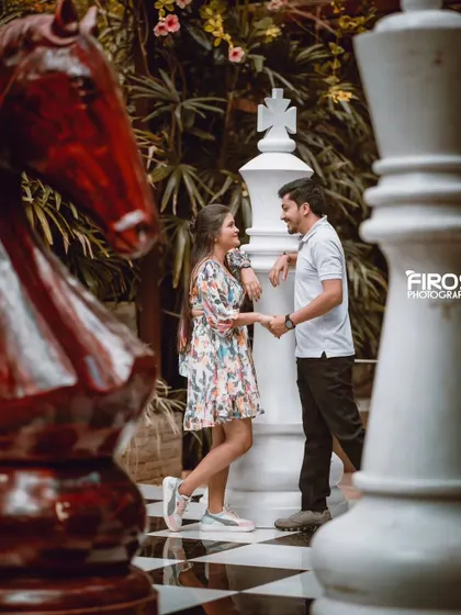 A beautiful, sepia-toned version of the couple on the giant chessboard, giving the photo a timeless, vintage feel.