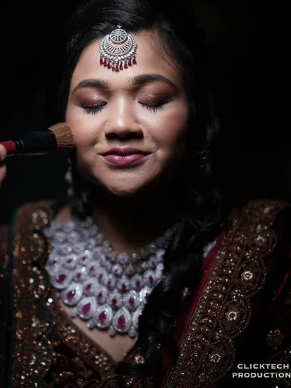 A close-up shot of the bride's makeup being applied, a key part of the getting-ready story.