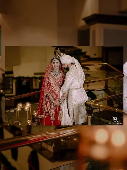 A romantic shot of the couple on a grand staircase, framed by candlelight.