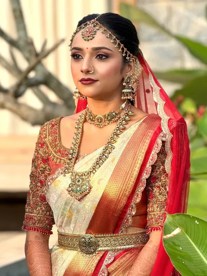 This bride is wearing a classic red and white Kanjeevaram saree. I created a corresponding makeup look with a bold red lip and defined eyes for a timeless bridal appearance.