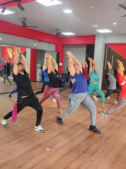 A moment of stretching and cool-down during a Zumba class. We always incorporate proper warm-ups and cool-downs for a complete and safe workout.