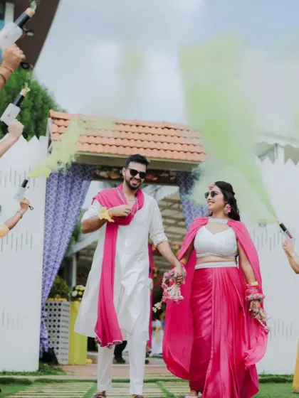 A grand welcome for the couple at their Haldi ceremony, with guests greeting them with colorful smoke cannons, creating a spectacular and photogenic moment.