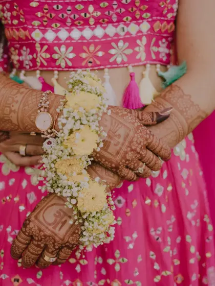 A close-up on the details. This shot highlights the bride's beautiful floral jewelry and intricate henna, key elements of the traditional Haldi look.