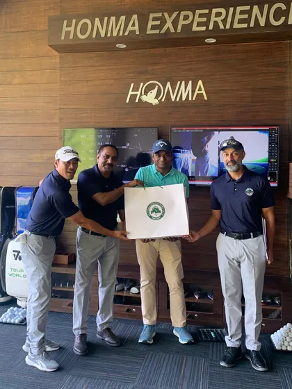 A Participant Receiving an Award at the Men's Golf Camp: Celebrating success on the greens. A participant is recognized for his achievements during the Men's Golf Camp, highlighting the progress made over the two-week program.