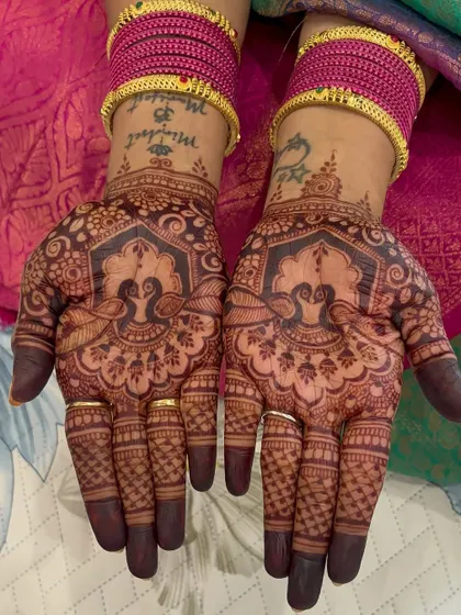 A close-up of the bride's mother's mehendi for the engagement, featuring beautiful peacock designs.