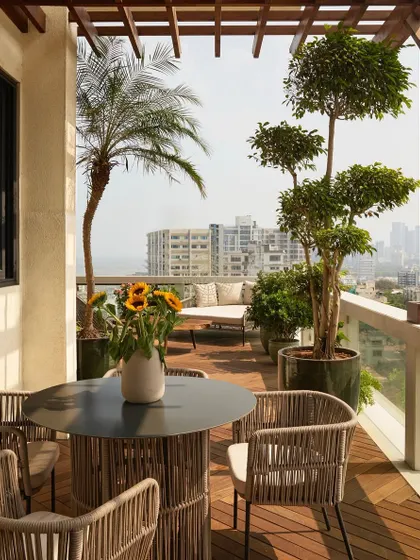 The living room opens directly onto this spacious deck with Brazilian IPE wood flooring. We furnished it with comfortable outdoor seating, creating an urban oasis with stunning views of the Mumbai skyline.