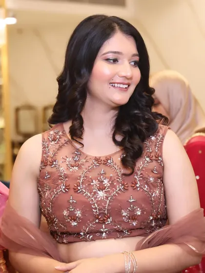 A close-up of her happy face. The makeup is light and fresh, perfect for a long day of festivities.