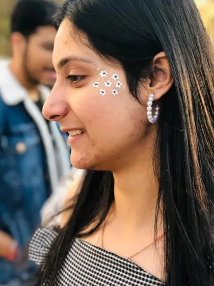 A scattering of tiny white flowers across the cheek, like delicate freckles. This is a very popular and whimsical style.