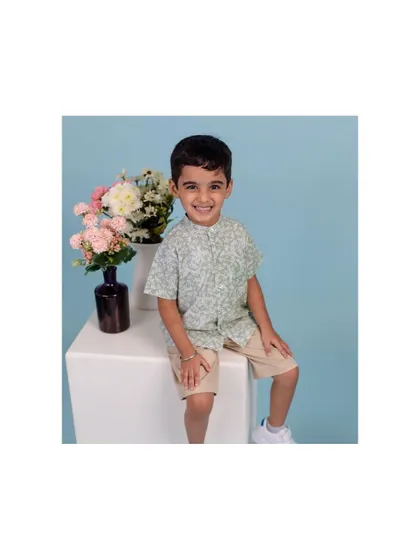 This young man’s bright smile made this studio session an absolute delight. We used a clean, simple backdrop with a pop of color from the flowers to keep the focus on his happy and charming personality.