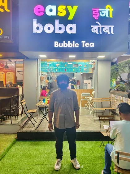 Our graduate Vishal, standing in front of his newly opened bubble tea and coffee shop in Pune. It's an incredible feeling to see our students turn their training into a tangible business.
