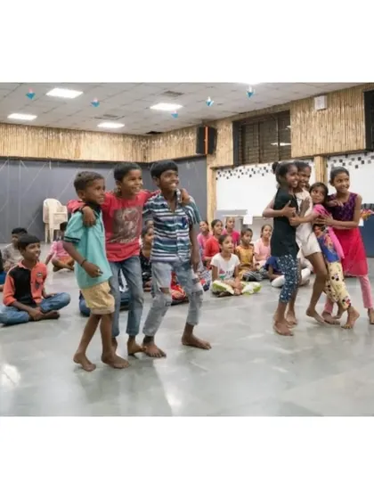 A beautiful, candid moment of friendship and fun. A group of boys from the workshop, arms around each other, sharing a laugh after a dance session.