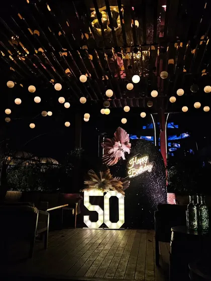 The full view of the rooftop party setup. I love transforming spaces like this to create a unique and memorable atmosphere for my clients' milestone celebrations.
