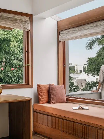 **Relic House, Ahmedabad:** We designed this home office to harmonize work and nature. A cozy window seat offers a place to pause and enjoy expansive views of the garden, creating a tranquil and inspiring work-from-home environment.