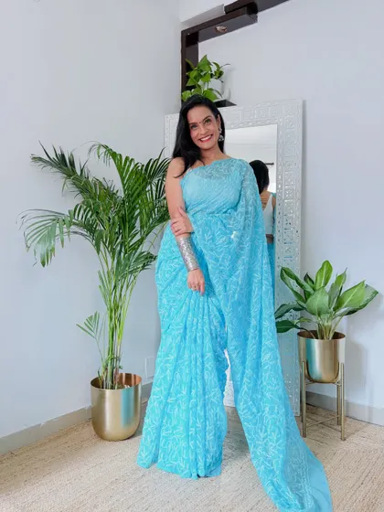 I love this shade of sky blue in a Chikankari saree. It's so refreshing and pretty. Paired with a simple white blouse, it makes for a very graceful and sophisticated look.