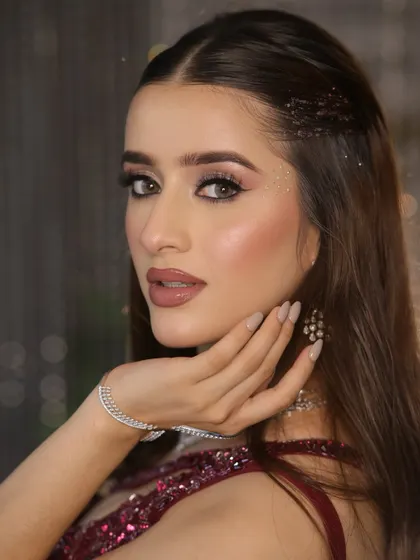 A close-up of a glamorous cocktail look. I focused on creating luminous, dewy skin, soft smokey eyes with a hint of sparkle, and a perfectly defined nude lip to achieve that sophisticated, camera-ready finish.