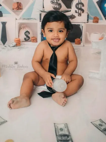 A happy boss baby with his milk bottle, surrounded by money bags and cash. This setup is all about fun and attitude.