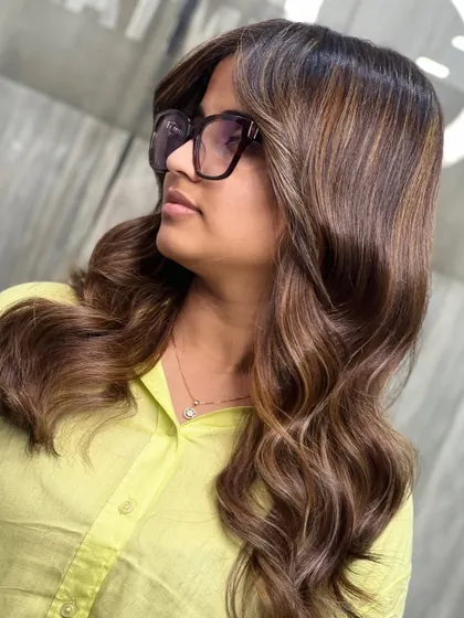 A side view of the sun-kissed blonde and warm brown blend, showing how the colors frame the face.