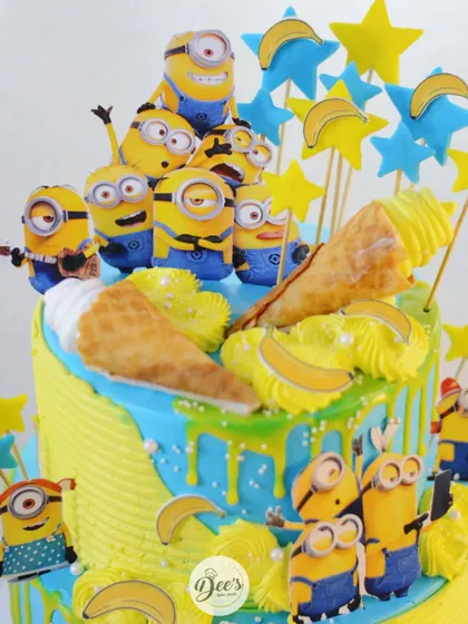 The top of the cake is a party of Minions, complete with ice cream cones and stars.