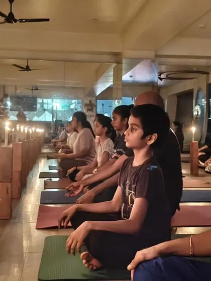 Tratak Kriya, or meditation through the eyes. A student gazes at a candle flame, a powerful practice we teach to cleanse the mind and sharpen concentration.