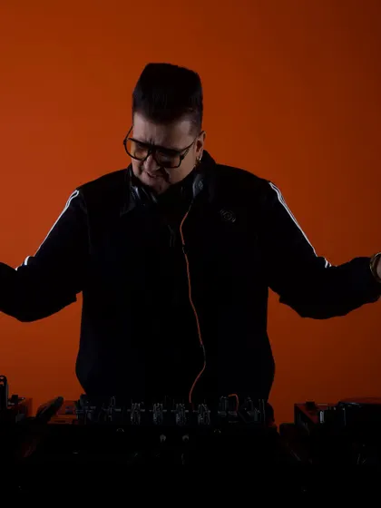 A silhouette shot against a bold orange background. This artistic photo captures the mood and atmosphere I create with my music.