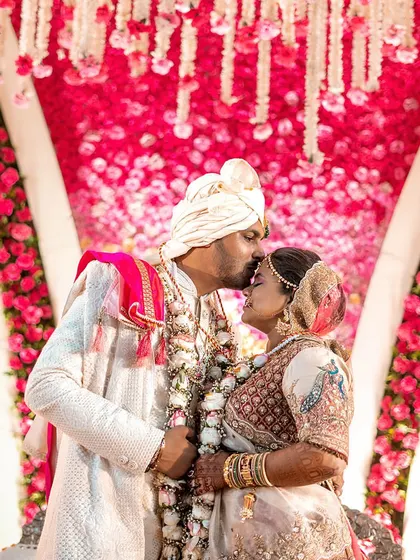 The timeless gradient of red hues creates a contemporary decor backdrop for this couple's wedding portrait.